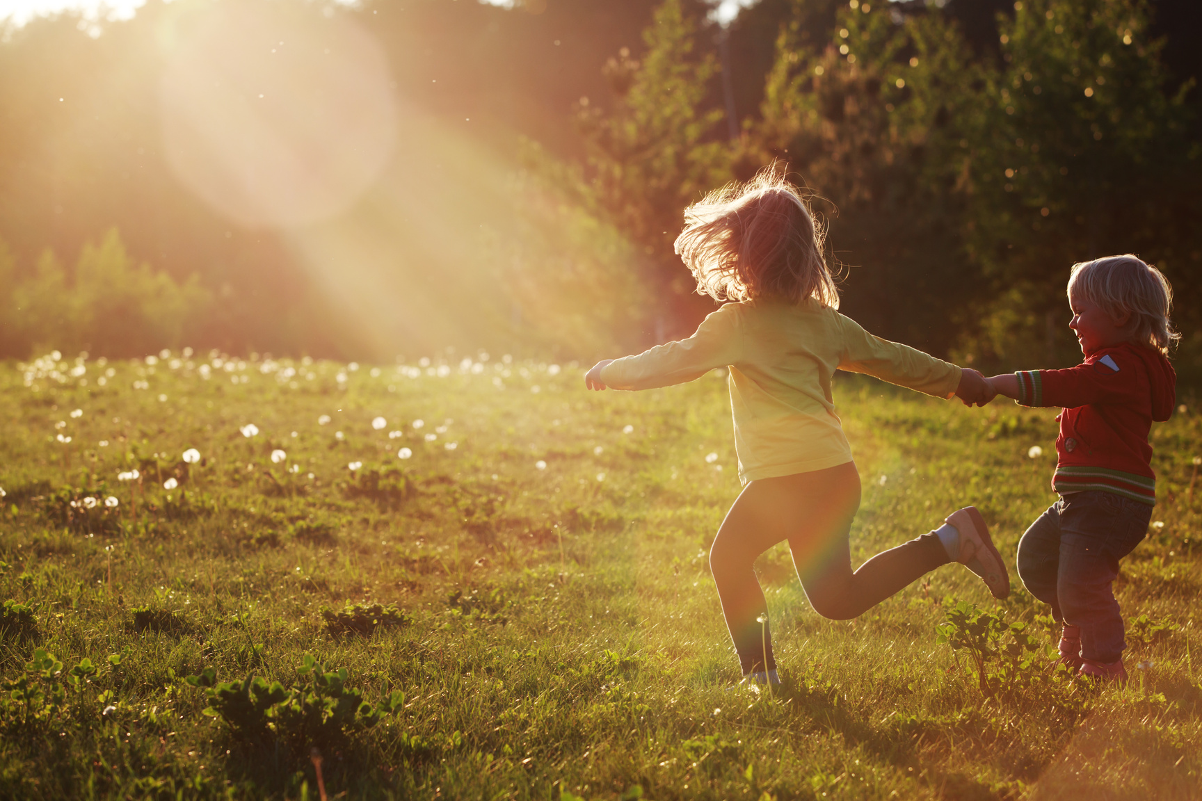 happy kids run play in sunset nature